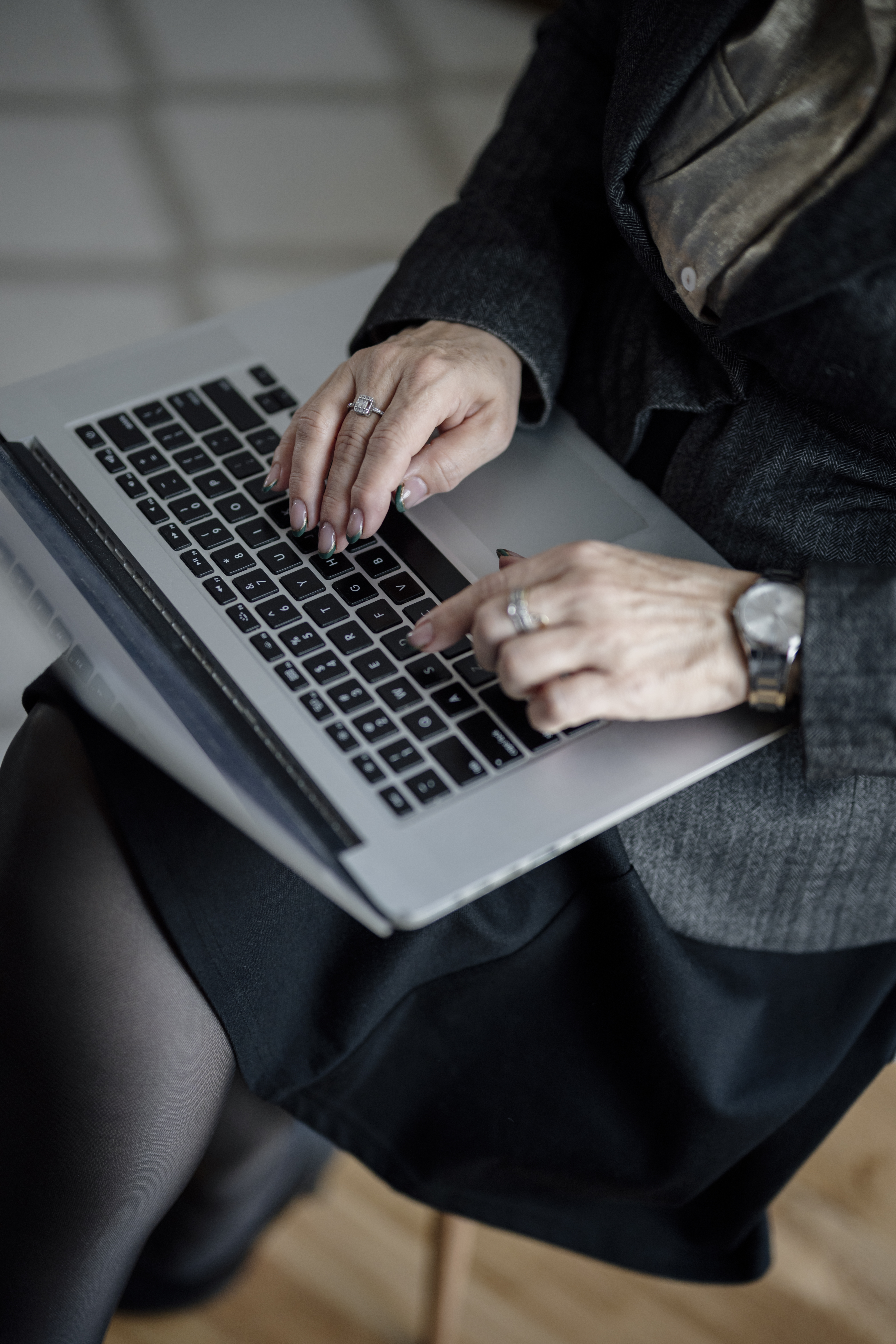 Hands typing on a laptop to manage mailbox rules and account settings